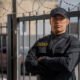 portrait male security guard with barbed wire fence 80x80